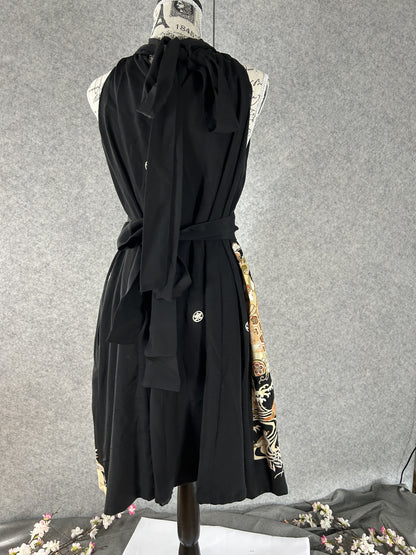 Back view of black halter dress with neck ties, sash and white family crest