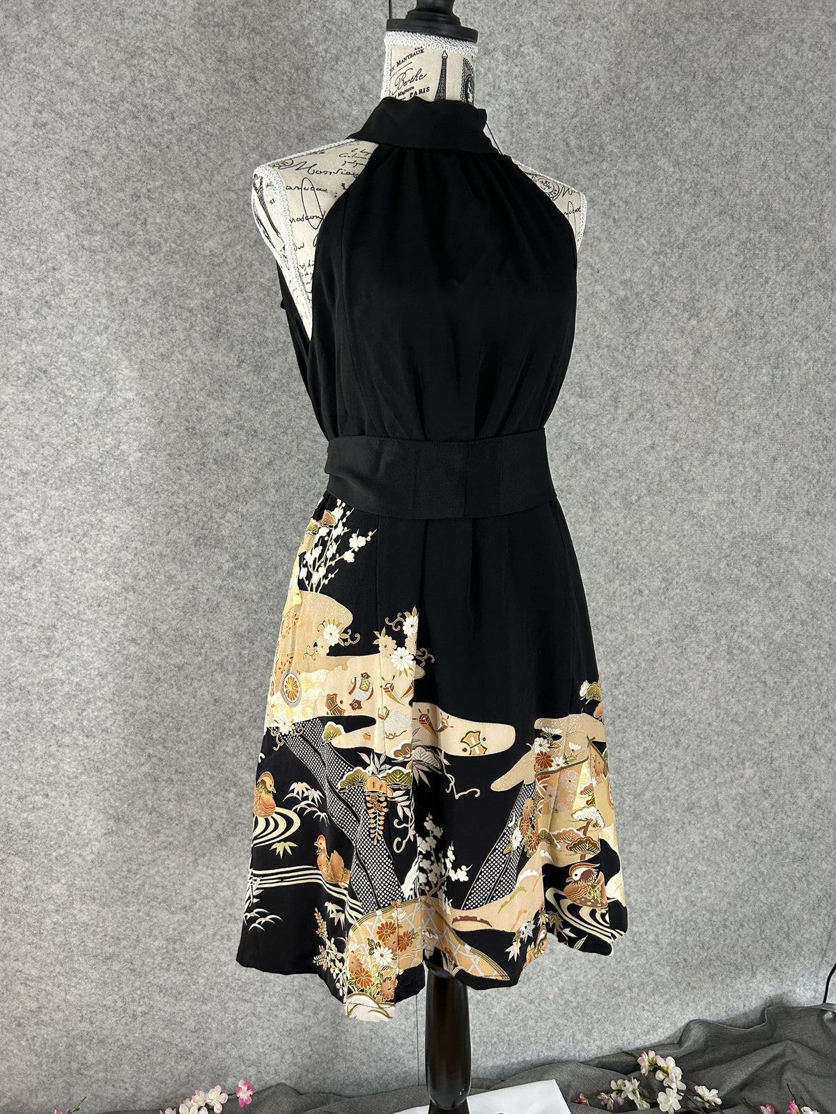 Black kimono halter dress with matching sash and scenic hem, front view