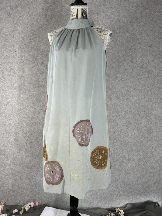 Sage green kimono halter dress with round mauve and bronze medallions, front view