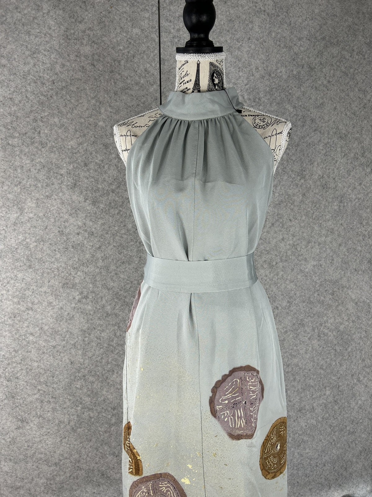 Sage green halter dress with gathered high neck and sash, front view