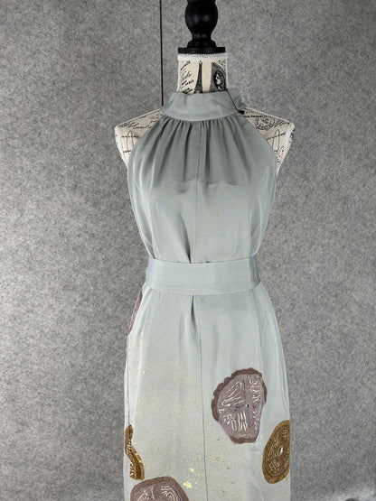 Sage green halter dress with gathered high neck and sash, front view