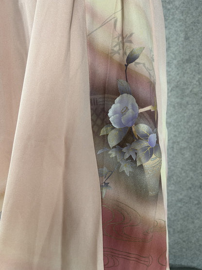 Detail of painted camellias and gold-outlined basket on pink kimono silk