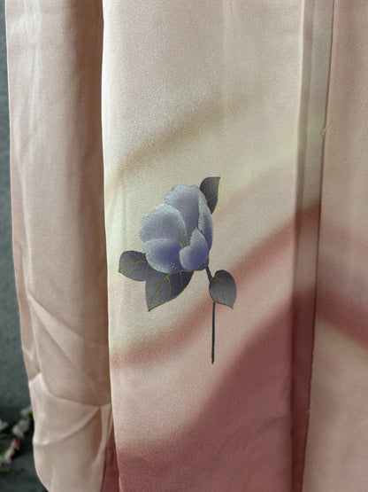 Detail of a blue-violet camellia on blush pink to rose kimono silk