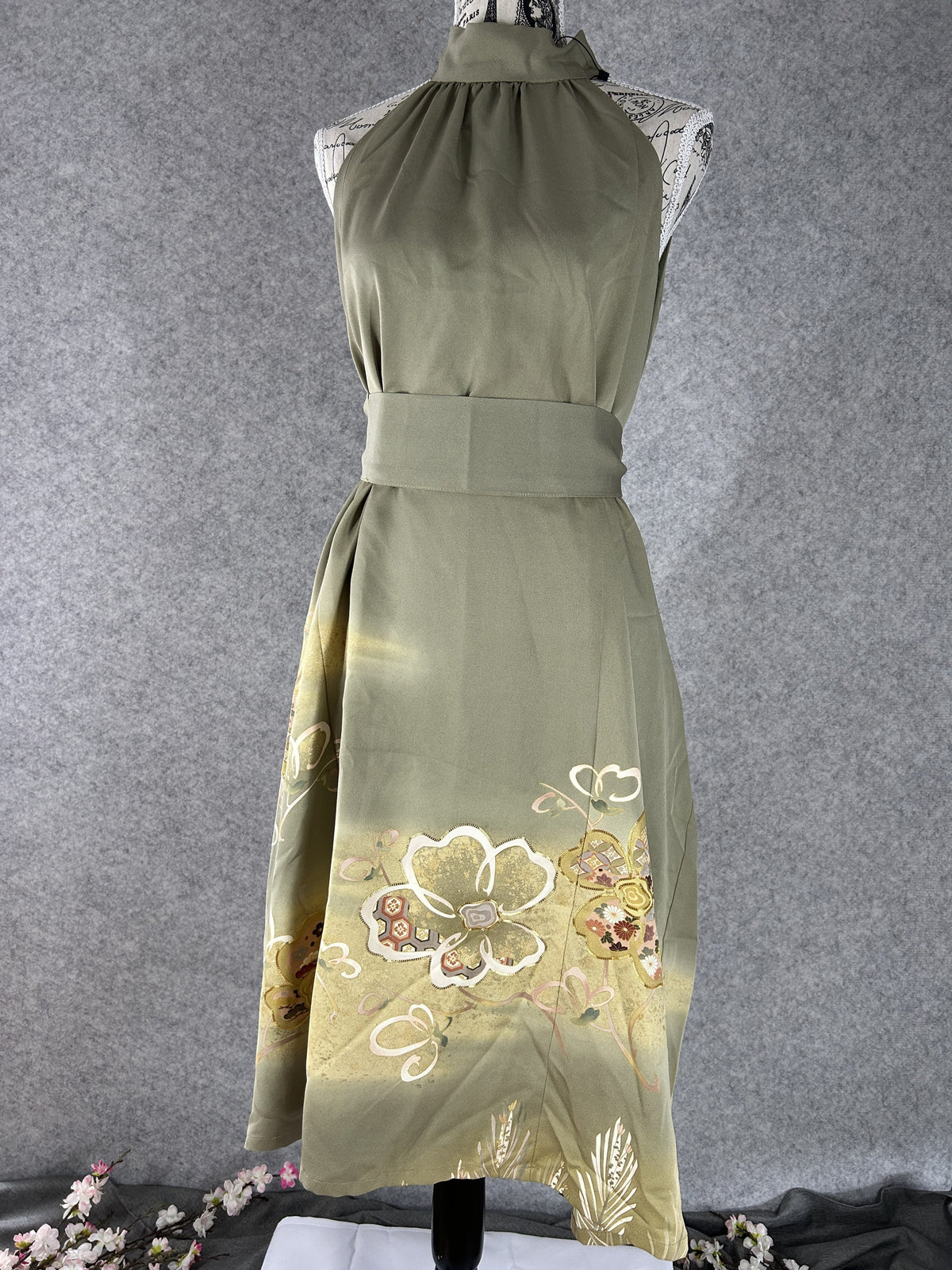 Sage green kimono halter dress worn with matching sash belt, front view