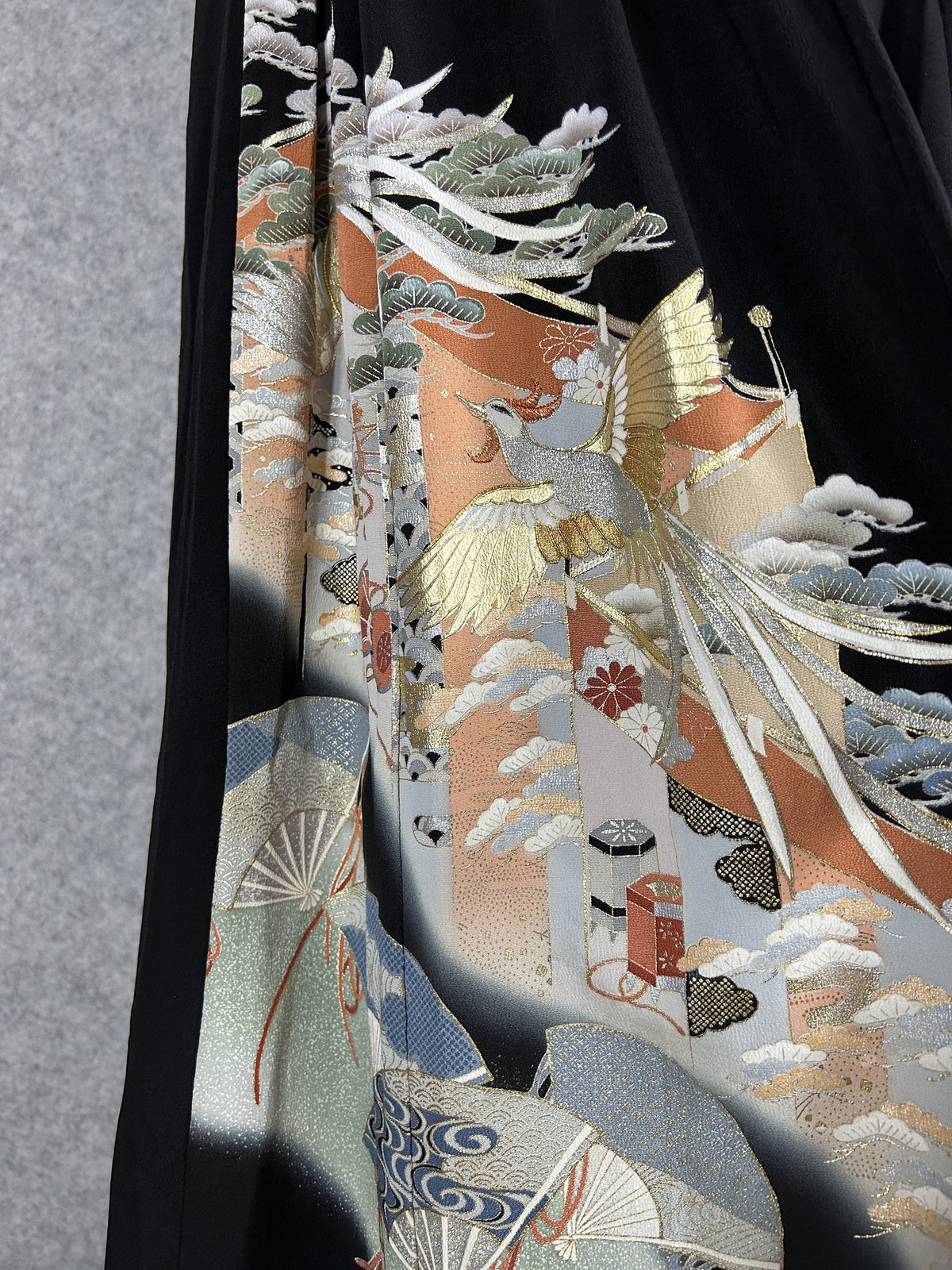 Black upcycled tomesode kimono hakama pants with a gold phoenix and fans, detail of the gold phoenix on the left leg