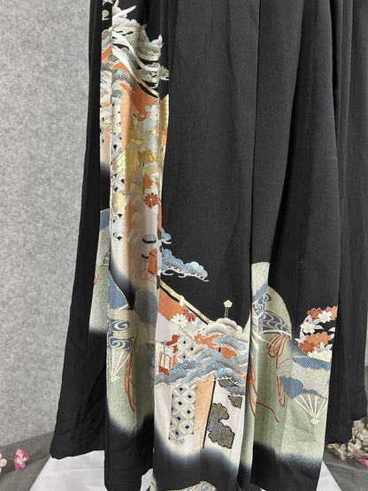 Black upcycled tomesode kimono hakama pants with a gold phoenix and fans, close-up of the hem with fans and clouds