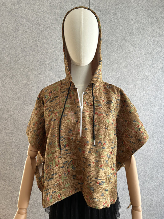 Beige-brown hooded kimono poncho with small multicolour pattern, front view