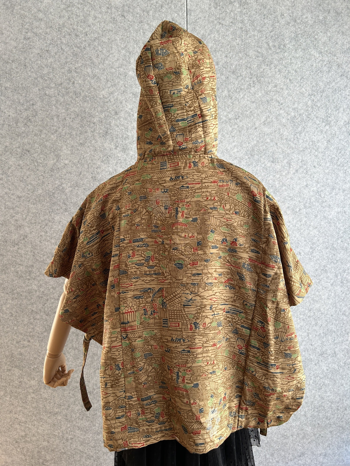 Beige-brown hooded kimono poncho with dense small pattern, back view