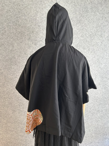 Black hooded kimono poncho with small patterned corner, back view