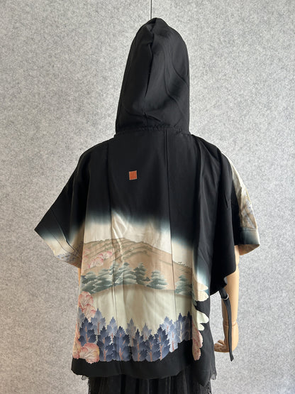 Black and cream hooded kimono poncho with landscape scene, back view
