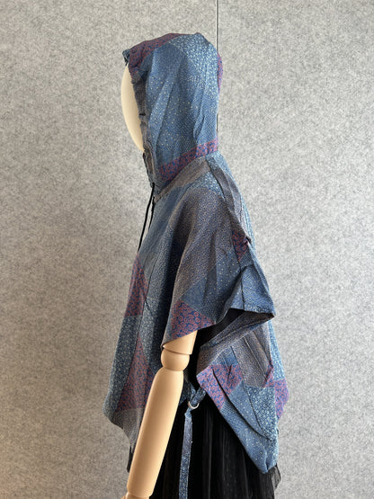 Blue hooded kimono poncho with patchwork of small patterns, side view