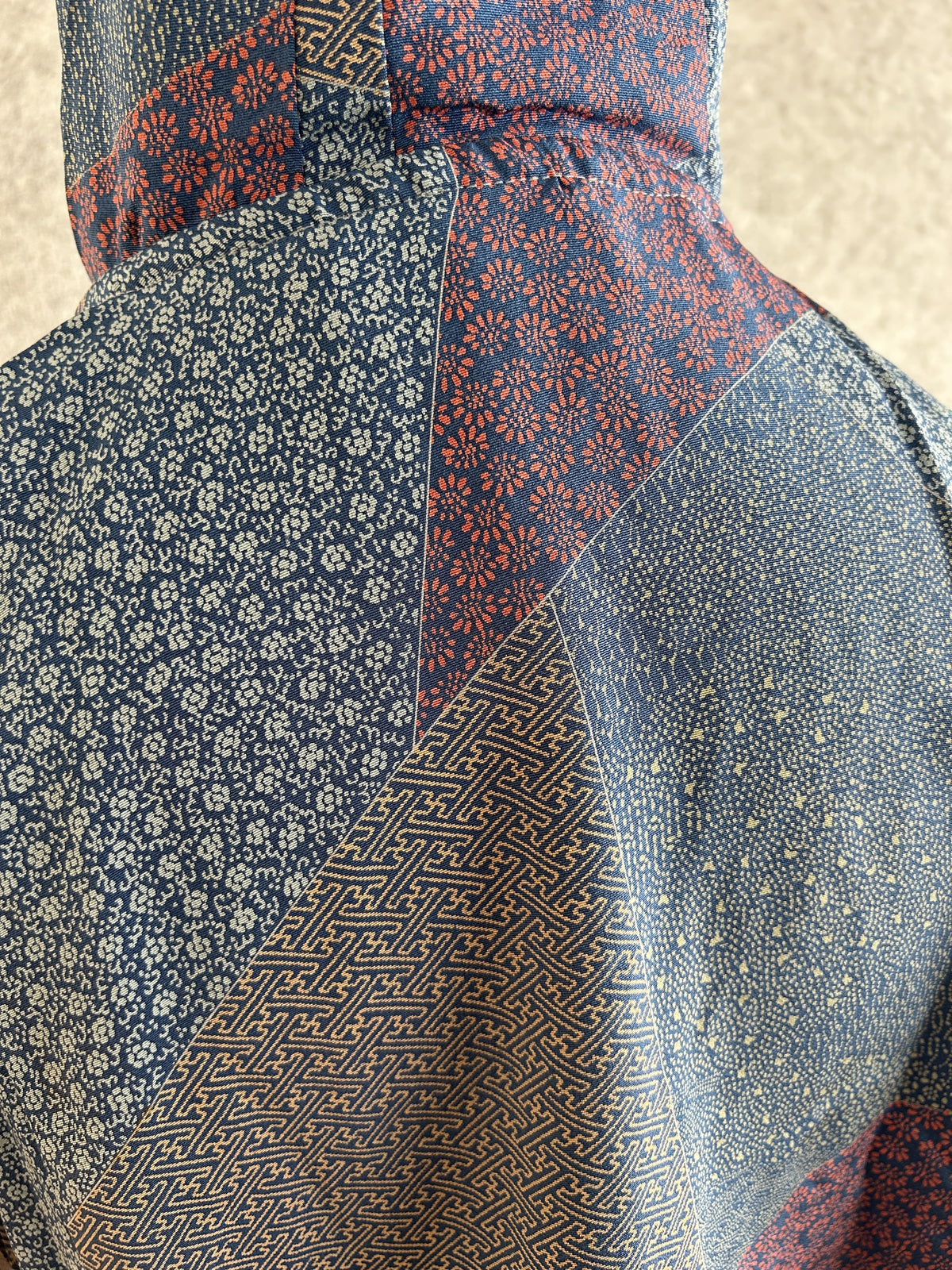 Blue hooded kimono poncho, detail of small floral and geometric patterns