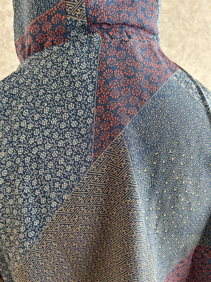 Blue hooded kimono poncho, detail of small floral and geometric patterns