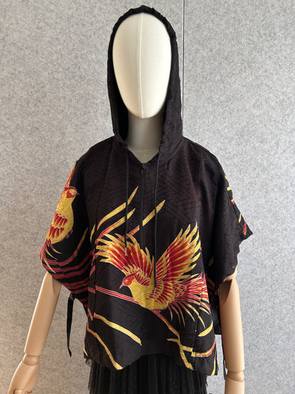 Black hooded kimono poncho with yellow and red bird motif, front view