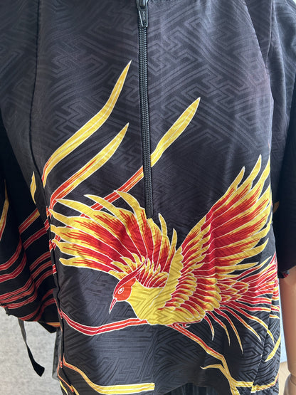Black hooded kimono poncho, detail of yellow and red bird and zipper