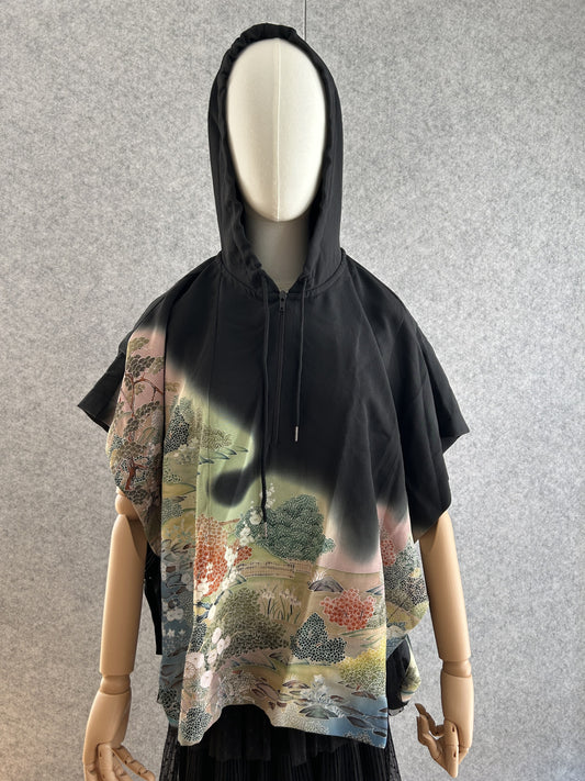 Black hooded kimono poncho with colourful garden landscape, front view