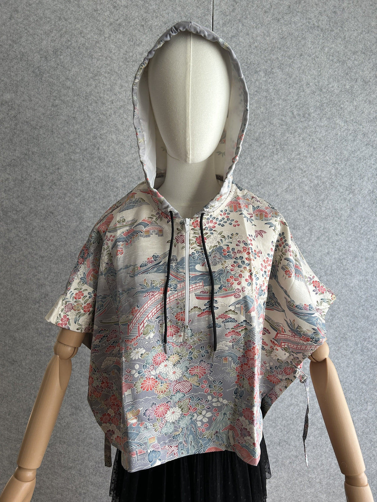 Cream hooded kimono poncho with red and blue floral scene, front view