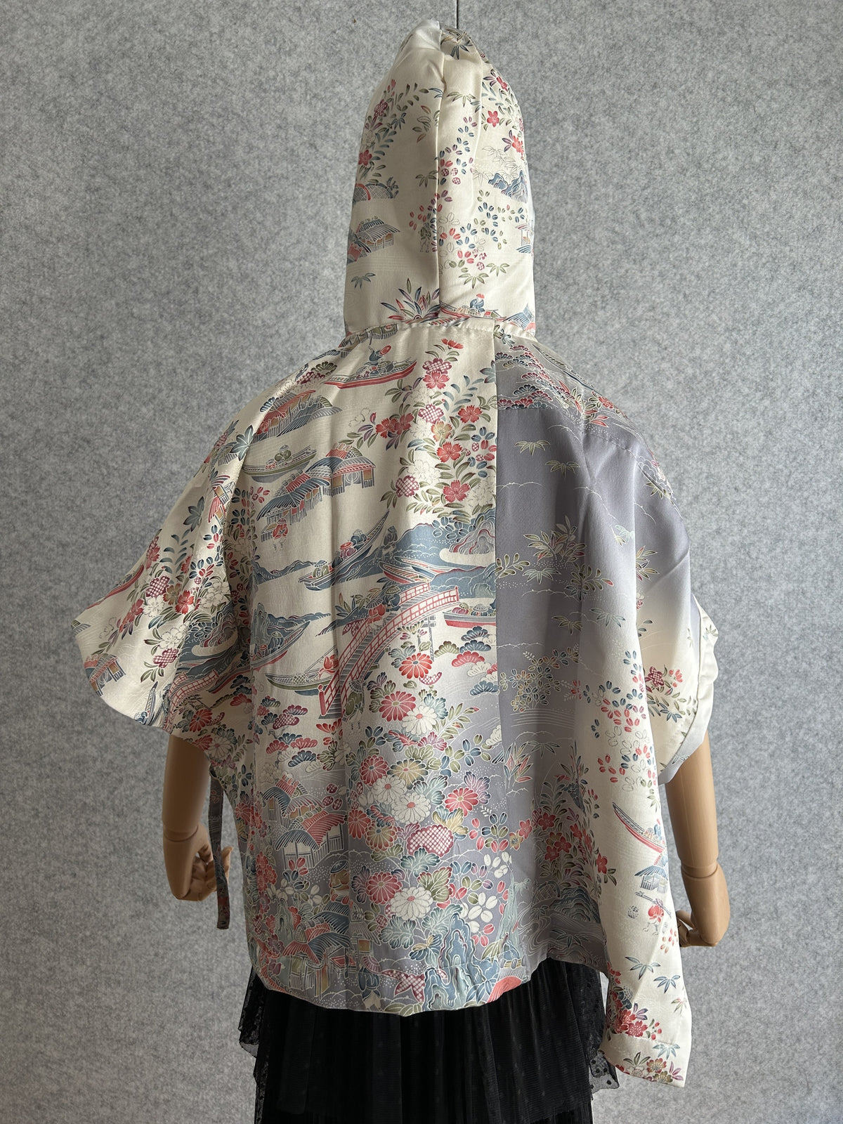Cream hooded kimono poncho with red and blue floral scene, back view