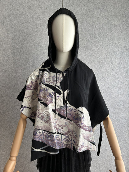 Black hooded kimono poncho with white cranes on purple band, front view