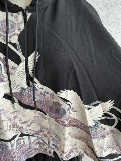 Black hooded kimono poncho, detail of crane, drawstrings and zipper
