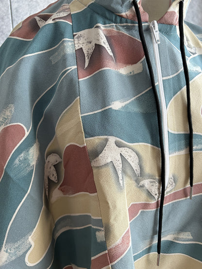 Teal blue hooded kimono poncho, detail of white leaves and white zipper