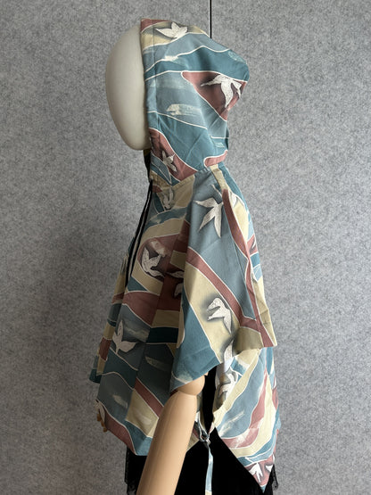 Teal blue hooded kimono poncho with yellow and red waves, side view
