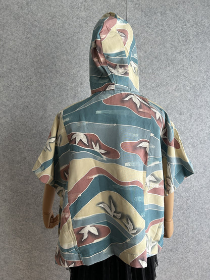 Teal blue hooded kimono poncho with yellow and red waves, back view