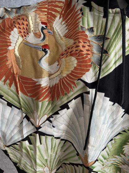 Black hooded kimono poncho, detail of orange crane with gold outlines