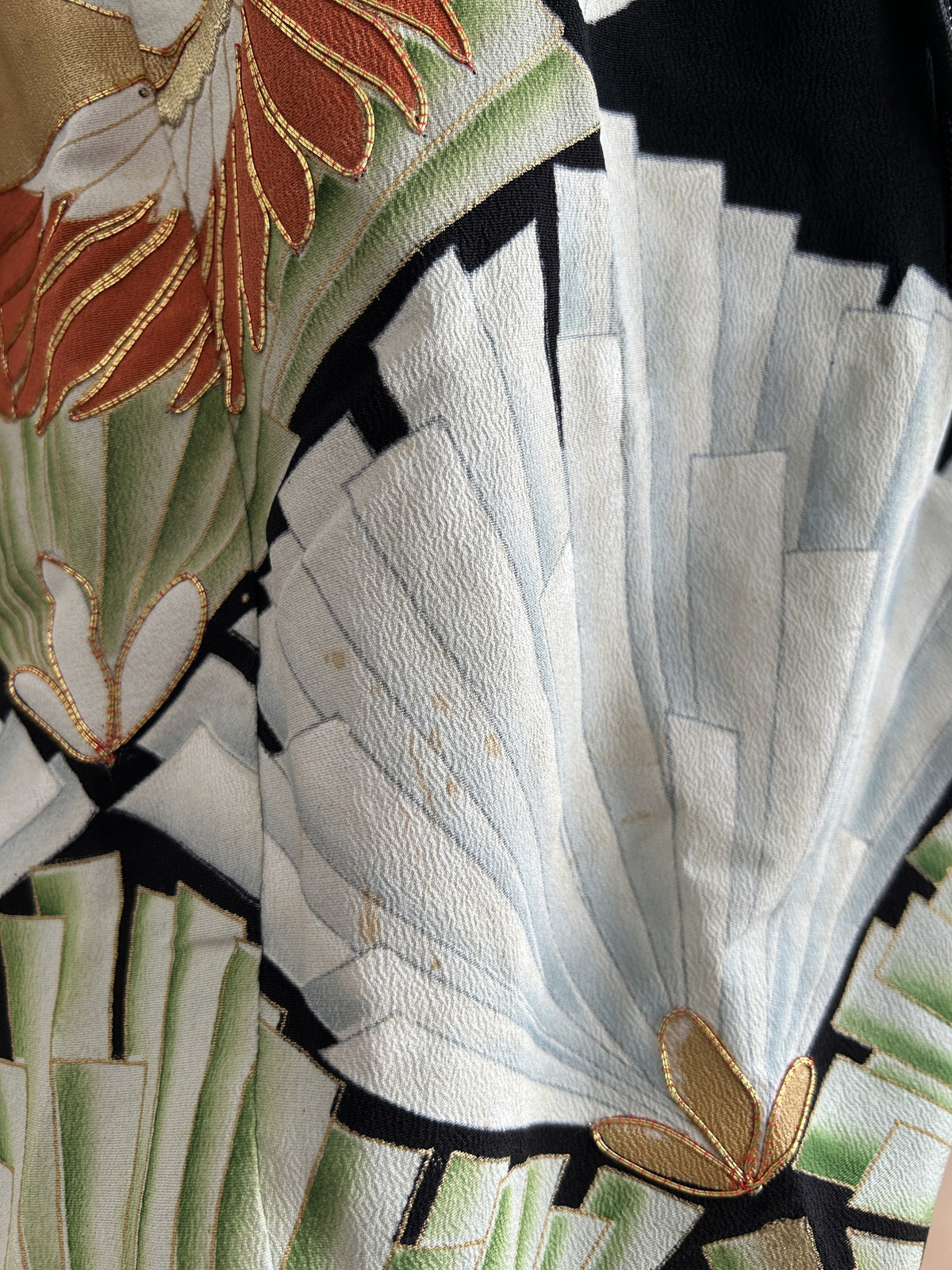 Black hooded kimono poncho, detail of white fan-shaped motif
