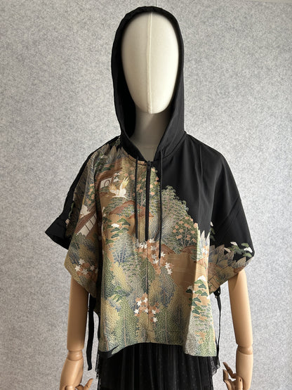 Black hooded kimono poncho with green and beige landscape scene, front view