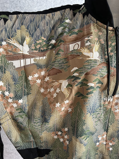 Black hooded kimono poncho, close-up of building, trees and flying cranes pattern