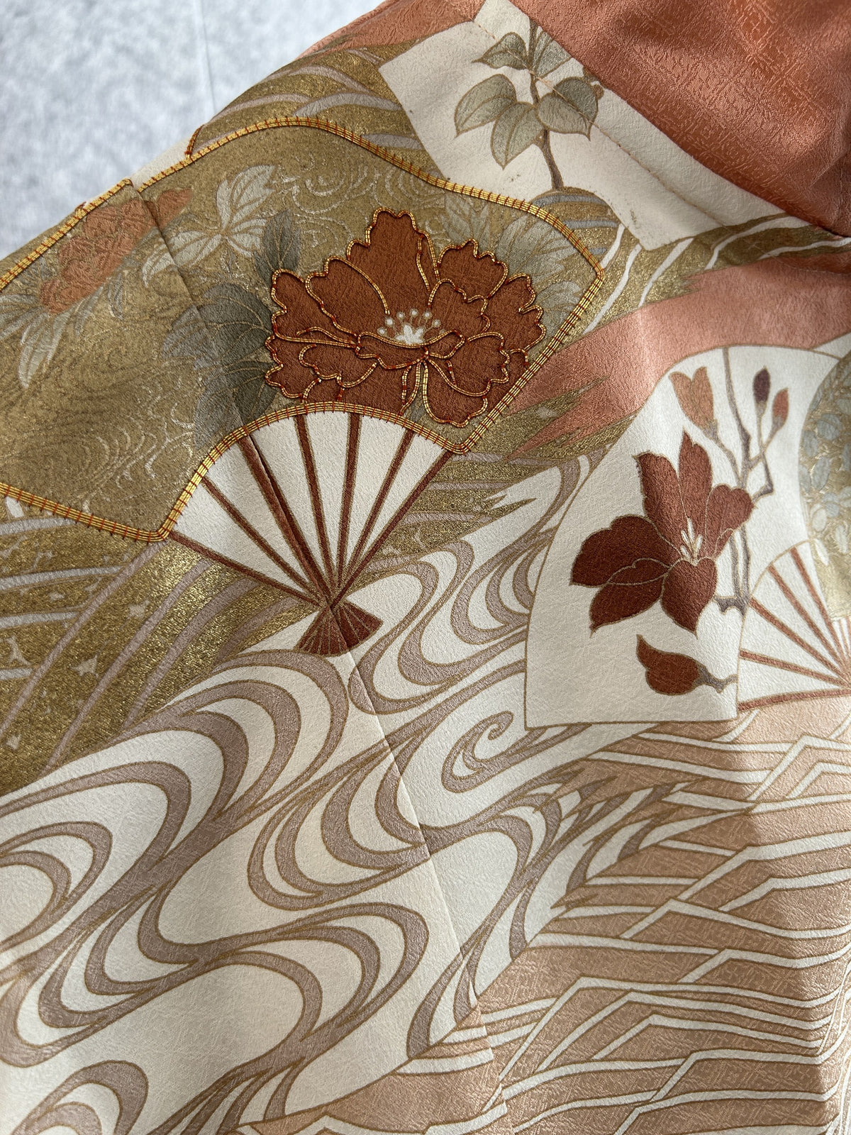 Salmon pink hooded kimono poncho, close-up of fans, flowers and wave lines