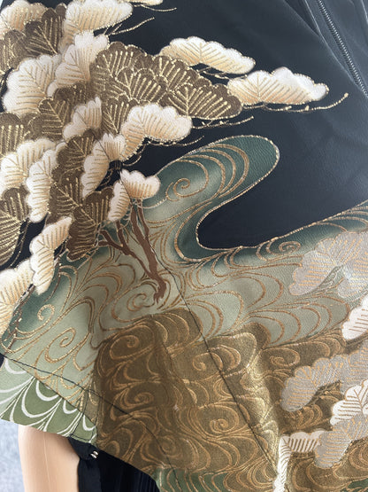 Detail of pine branches and gold-outlined green water swirls