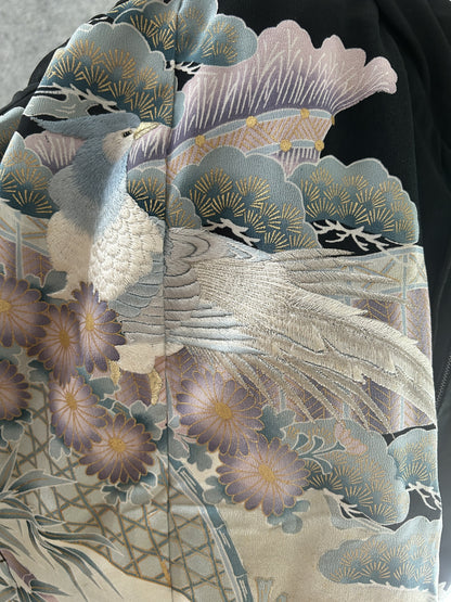 Detail of a long-tailed bird with lilac flowers and pine in pastels