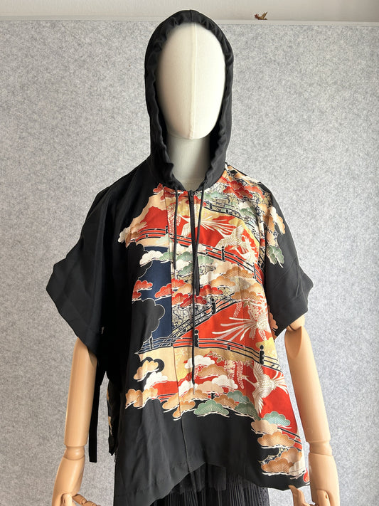 Black hooded kimono poncho with red and gold bird scene, front view