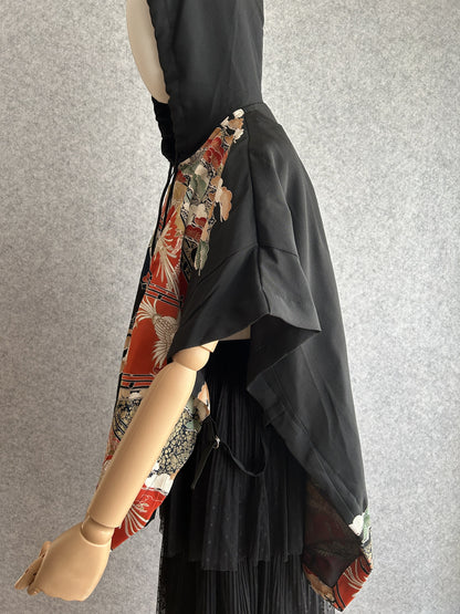 Black hooded kimono poncho with red patterned front, side view
