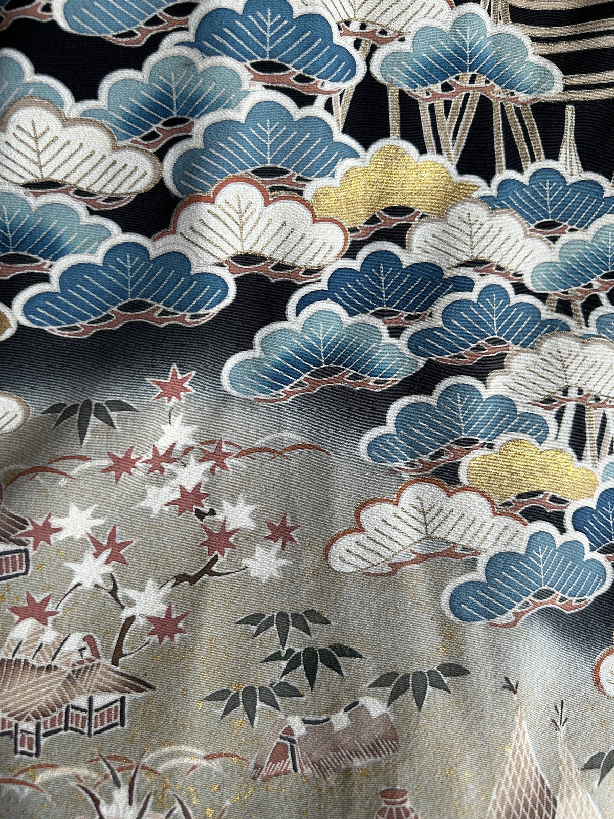 Black hooded kimono poncho, detail of pine trees, maple leaves and small houses