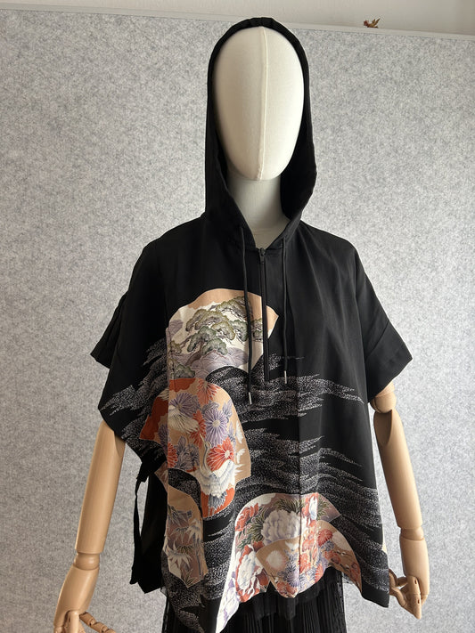 Black hooded kimono poncho with crane and chrysanthemum fan panels, front view