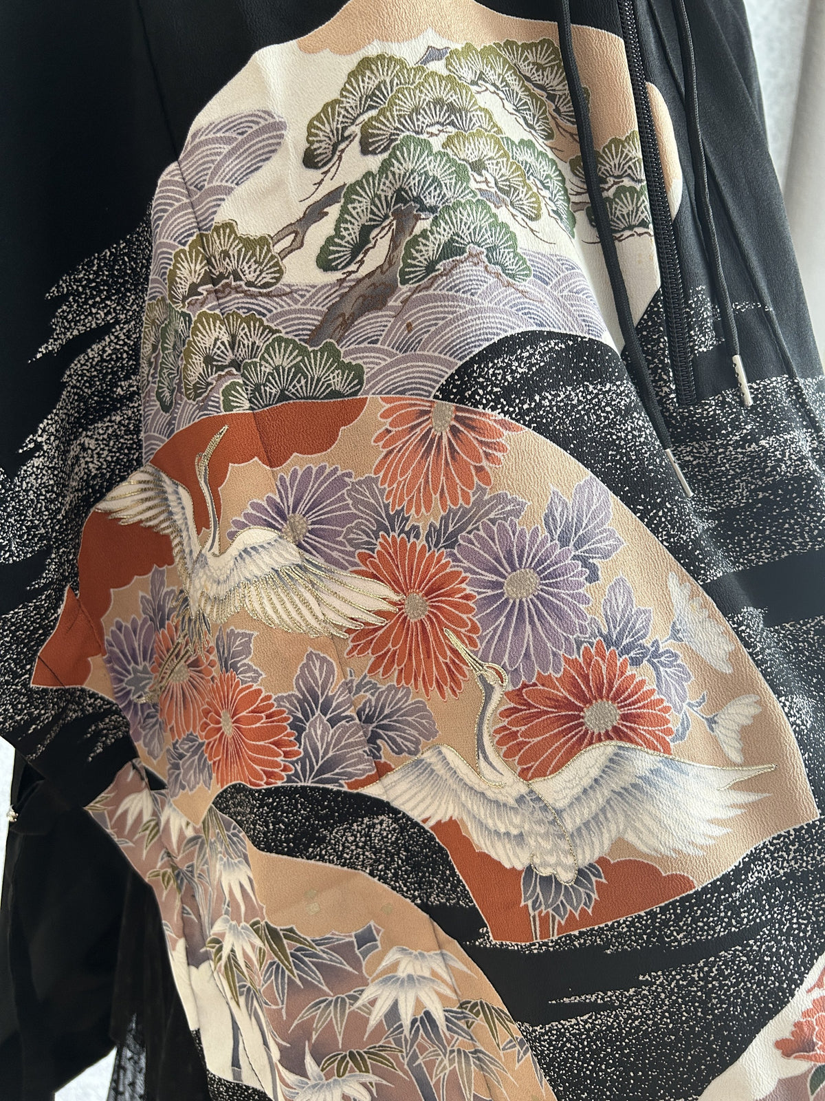 Black hooded kimono poncho, close-up of white cranes, chrysanthemums and pine tree