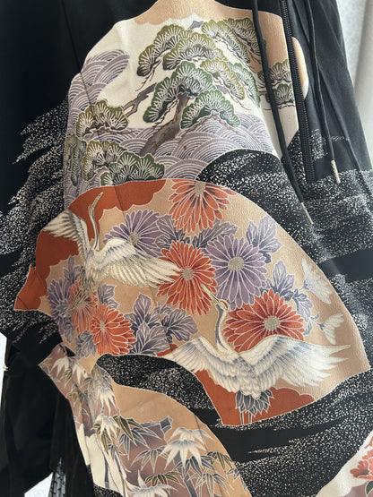 Black hooded kimono poncho, close-up of white cranes, chrysanthemums and pine tree