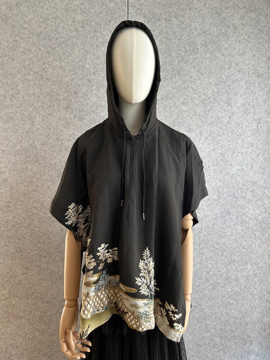 Black hooded kimono poncho with white and gold tree scene at hem, front view