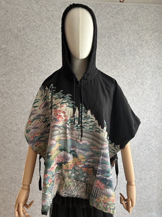 Black hooded kimono poncho with pastel garden scene in teal and pink, front view