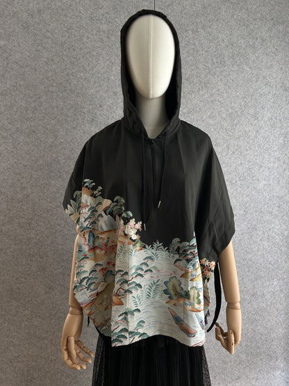 Black hooded kimono poncho with pale waterside landscape scene, front view