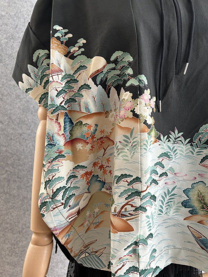 Black hooded kimono poncho, close-up of pine trees, blossoms and boats at the hem