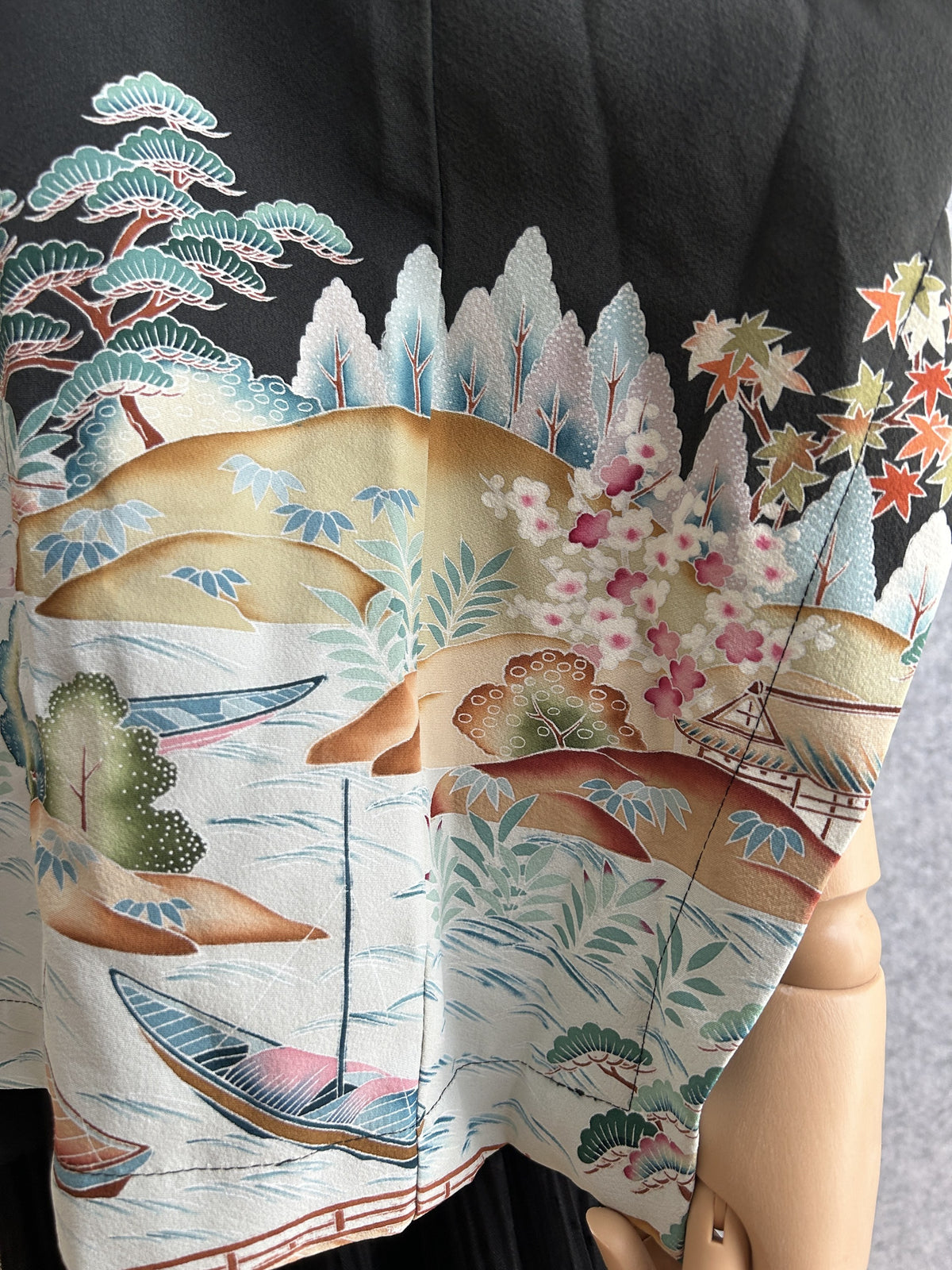 Black hooded kimono poncho, detail of boats, blossoms and maple leaves on water