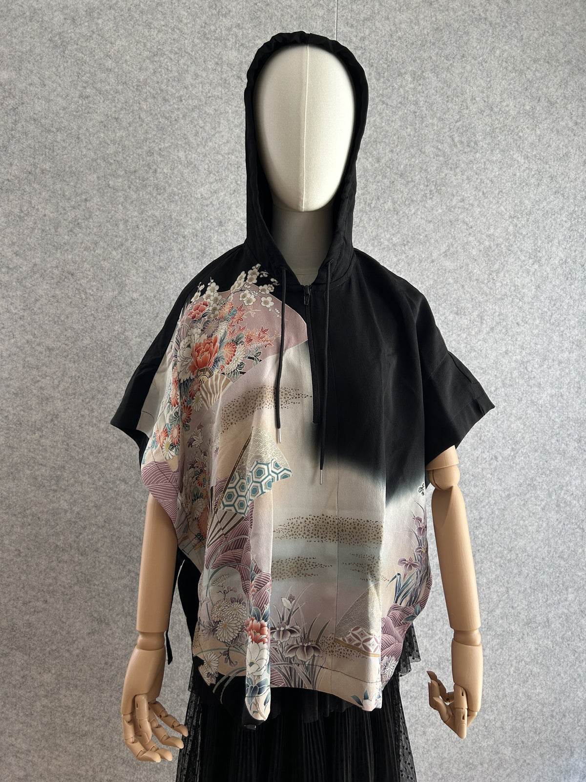 Black hooded kimono poncho with pastel floral and fan design, front view