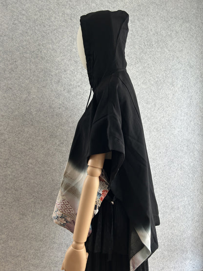 Black hooded kimono poncho with pastel floral side panel, side view