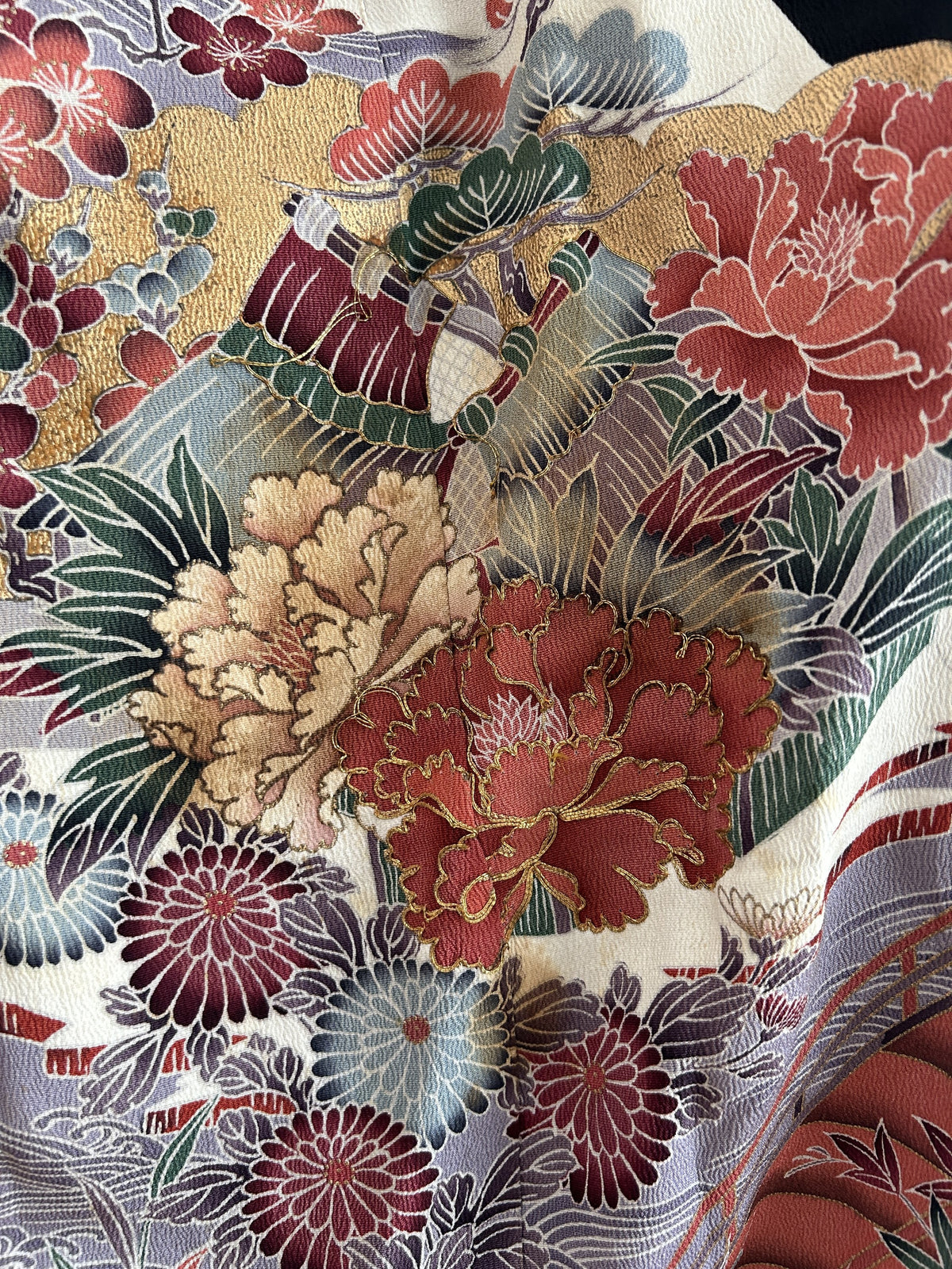 Black hooded kimono poncho, close-up of coral and cream peonies with gold outlines