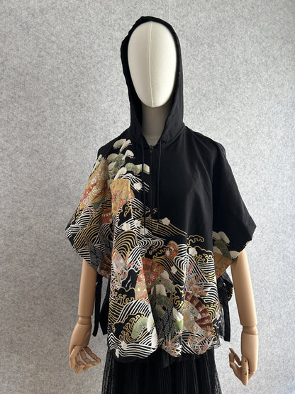 Black hooded kimono poncho with white waves and gold fans, front view