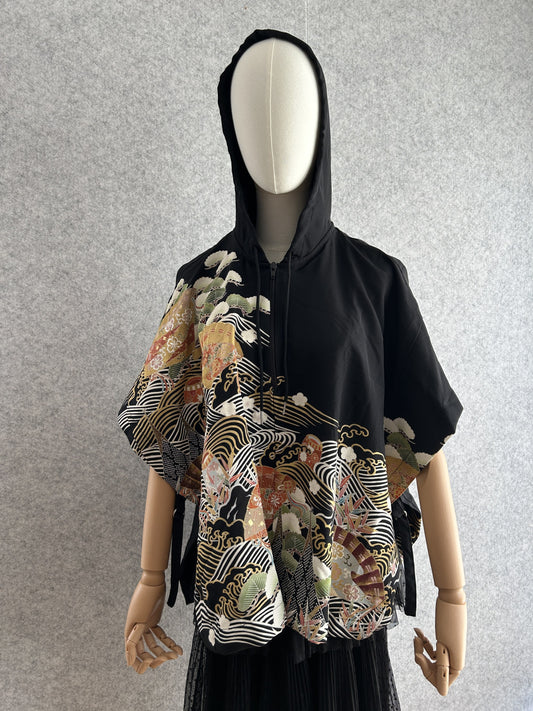 Black hooded kimono poncho with white waves and gold fans, front view